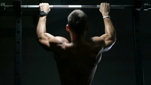 Fitness man doing pull-ups exercises in gym Video stock 144560306