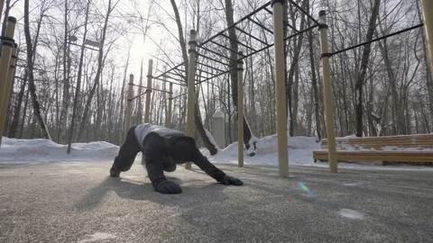 Fitness man doing push ups and stretching exercises on winter sports training Stock Footage 87891591