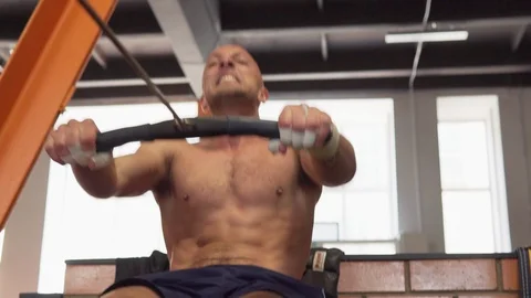 Fitness man doing rowing workout in gym Stock Footage 90467405