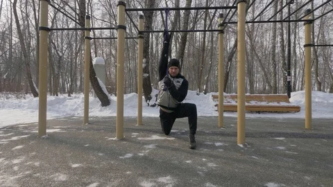 Fitness man doing workout exercises with expander on sports ground Stock Footage 87892211