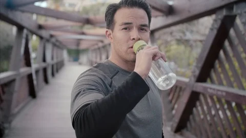 Fitness man drinking clean cool water from eco friendly bottle after fitness Stock Footage 104490762