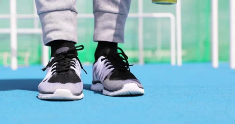 Fitness man getting ready tying running shoes with green smoothie juice detox Stock Footage 220144060