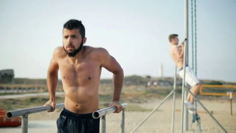 Fitness man pushing on parallel bars. Sportsman doing pull ups on crossbar Stock-Footage 79172193