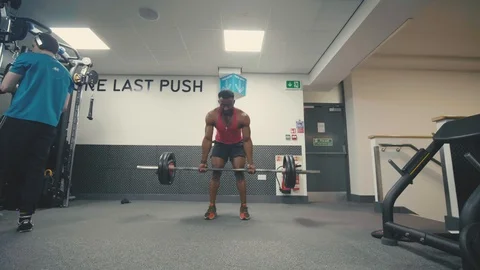 Fitness model doing barbell rows in the gym. Tracking in shot, slow motion Stock Footage 89577218