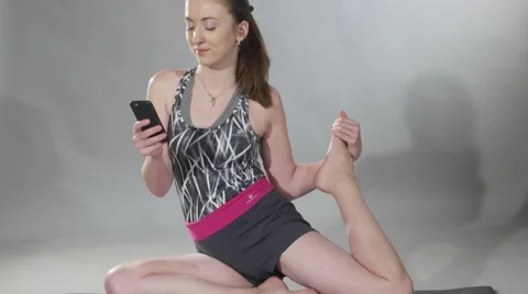 Fitness model on floor during exercise with music by mobile phone Stock Footage 62468533