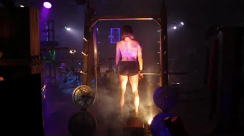 Fitness Model Lifting Weights Behind Stock Footage 32398850