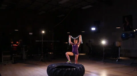 Fitness Model Posing With Chains and Tire Stock Footage 30392317