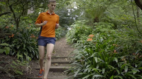 Fitness Model Runs Down Steps, Toward Camera, On A Beautiful Forest Trail (4K) Stock Footage 50012401