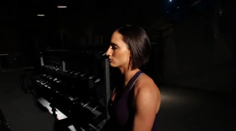 Fitness Model Trainer Resting in Dark Gym Stock Footage 30392201
