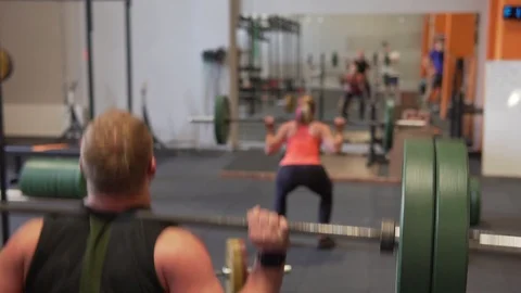 Fitness people doing back squat exercise in gym Stock Footage 90467427