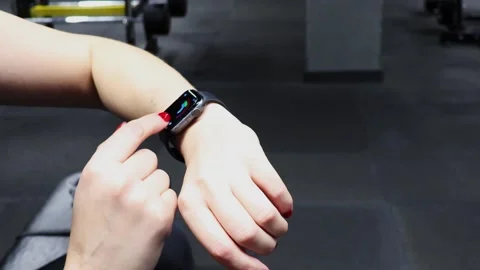 Fitness progress while working out in the gym with wearable tech on display Video stock 295281805