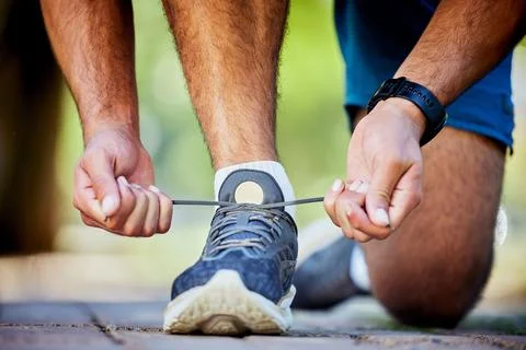 Fitness, running and man tie shoes for exercise, marathon training and cardio Stock Photos