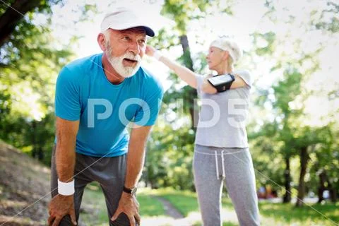 Fitness, sport, people, exercising and lifestyle concept - senior couple running Stock Photos