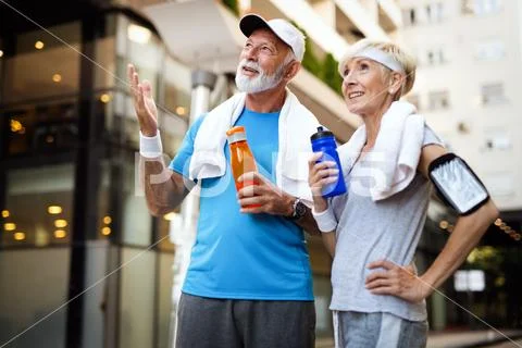 Fitness, sport, people, exercising and lifestyle concept - senior couple running Stock Photos
