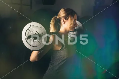 Fitness, sport, powerlifting and people concept - sporty woman exercising with Stock Photos