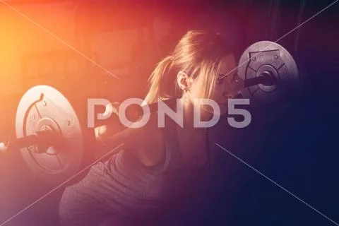 Fitness, sport, powerlifting and people concept - sporty woman exercising with Stock Photos