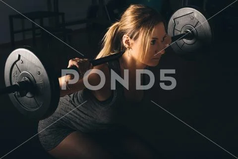 Fitness, sport, powerlifting and people concept - sporty woman exercising with Stock Photos