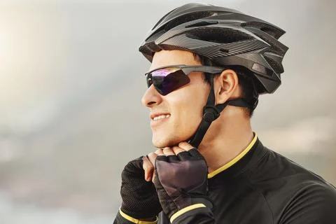 Fitness, sports and cyclist checking his helmet before cycling, training Stock Photos