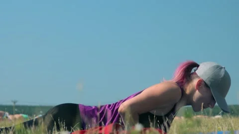 Fitness trainer doing push-ups outdoors Stock Footage 138579043