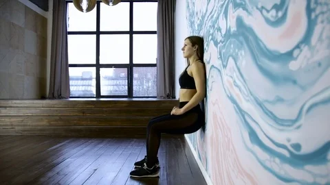 The fitness trainer doing squats. athletic and beautiful woman. Three frame. Video stock 83767213