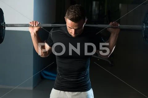 Fitness Trainer Doing Squats With Barbells Stock Photos