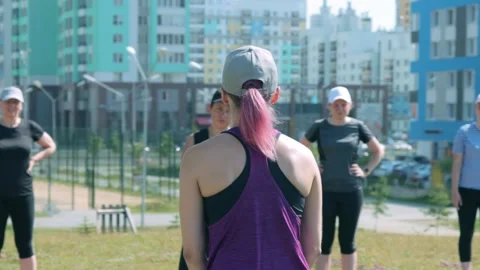Fitness trainer explaining how to do exercise Stock Footage 138576194