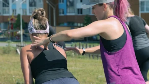 Fitness trainer explaining how to do exercise properly Stock Footage 138580125