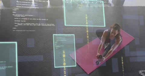 Fitness trainer holding hamstring stretch on mat, binary code panels animating Stock Footage 316966560