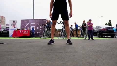 Fitness trainers do exercises in public Stock Footage 169595055