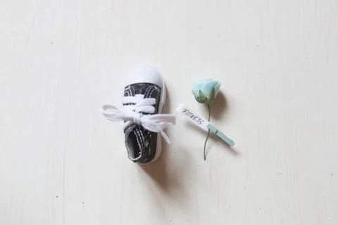 Fitness training concept, flower with text and one shoe Stock Photos