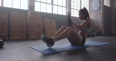 Fitness woman working out on core muscles at crossfit gym Stock Footage