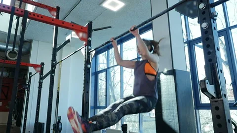 Fitness workout. Girl does pulling up exercises. Slow motion Stock Footage 106197860