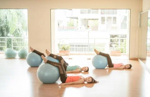 Fitness - Young Asia women doing yoga training or workout with gymnastic ball Stock Photos