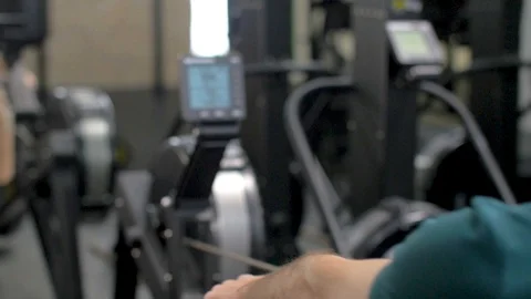 Fitness young man using rowing machine in the gym Stock Footage 112718526