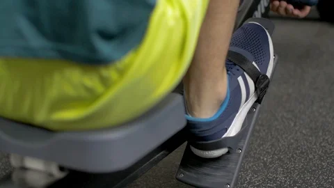 Fitness young man using rowing machine in the gym Stock Footage 112719651