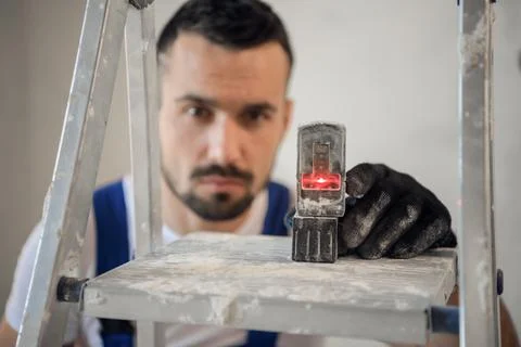 The fitter uses an electronic ruler, close-up Stock Photos