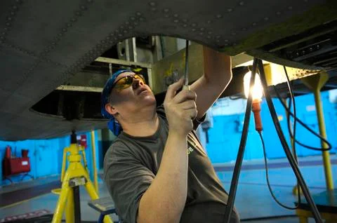 Fitter works with a screwdriver Stock Photos