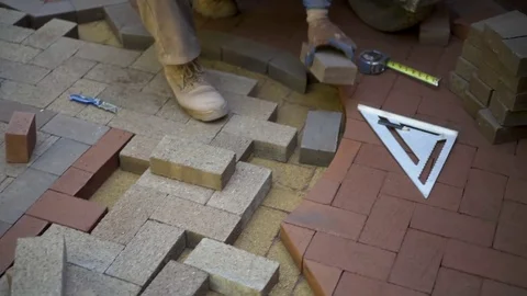 Fitting bricks into a custom designed and cut brick pattern as part of a Stock Footage 81590922