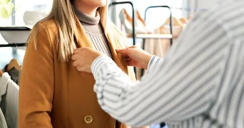 Fitting, coat and hands of designer with woman in store for shopping, disco.. Stock Photos