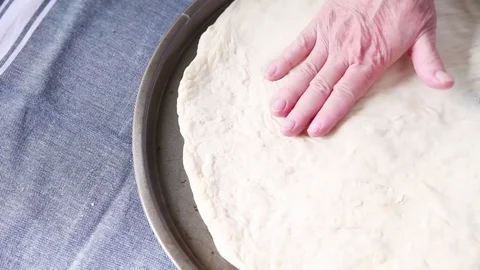 Fitting dough to pizza pan Stock Footage 75422320