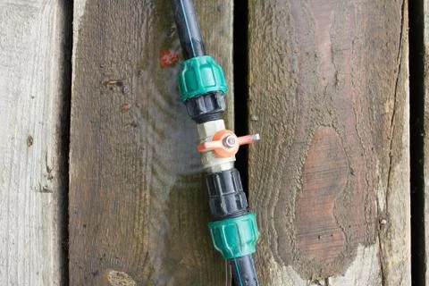 Fitting on a green hose Stock Photos