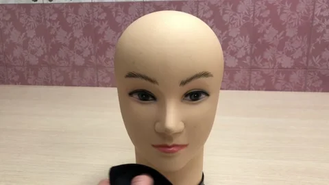 Fitting a mask on a mannequin's head Stock Footage 130580918