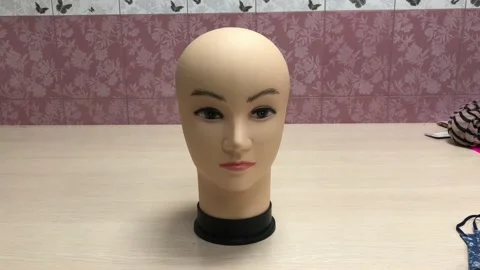 Fitting a mask on a mannequin's head Stock Footage 130580944