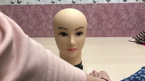Fitting a mask on a mannequin's head Stock Footage 130580977