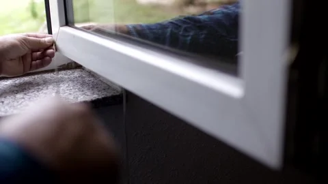 Fitting a rubber seal into a plastic window frame, granite sill detail Stock Footage 341525350