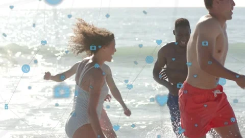 Five adults entering surf, running and splashing for lifestyle while blue icons Stock Footage 333689557