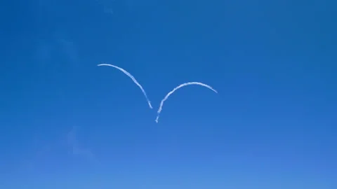 Five airplanes flying in sky, leaving condensation trail in shape of a heart. 4K Video stock 95758746