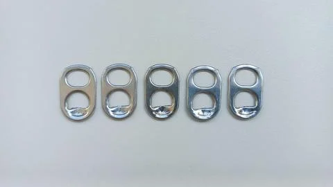 Five Aluminum Can Pull Tabs in a Row Stock Photos