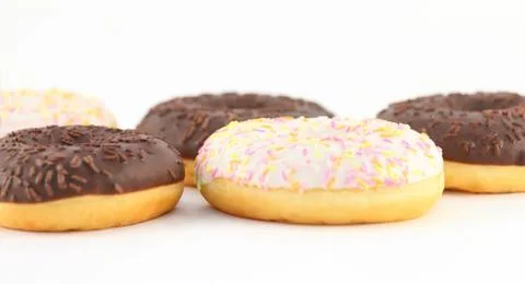 Five appetizing sweet white and chocolate donuts, close up view Stock Photos