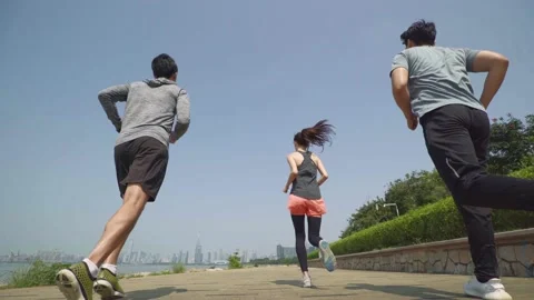 Five asian young adults running outdoors Stock Footage